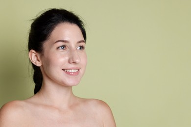 Photo of Smiling woman after dental aligners treatment on green background. Space for text