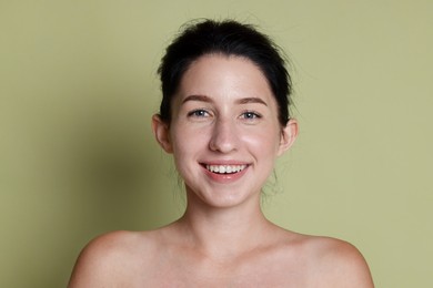 Photo of Portrait of smiling woman after dental aligners treatment on green background, closeup