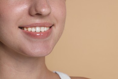 Photo of Smiling woman after dental aligners treatment on beige background, closeup. Space for text