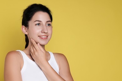 Photo of Smiling woman after dental aligners treatment on yellow background. Space for text