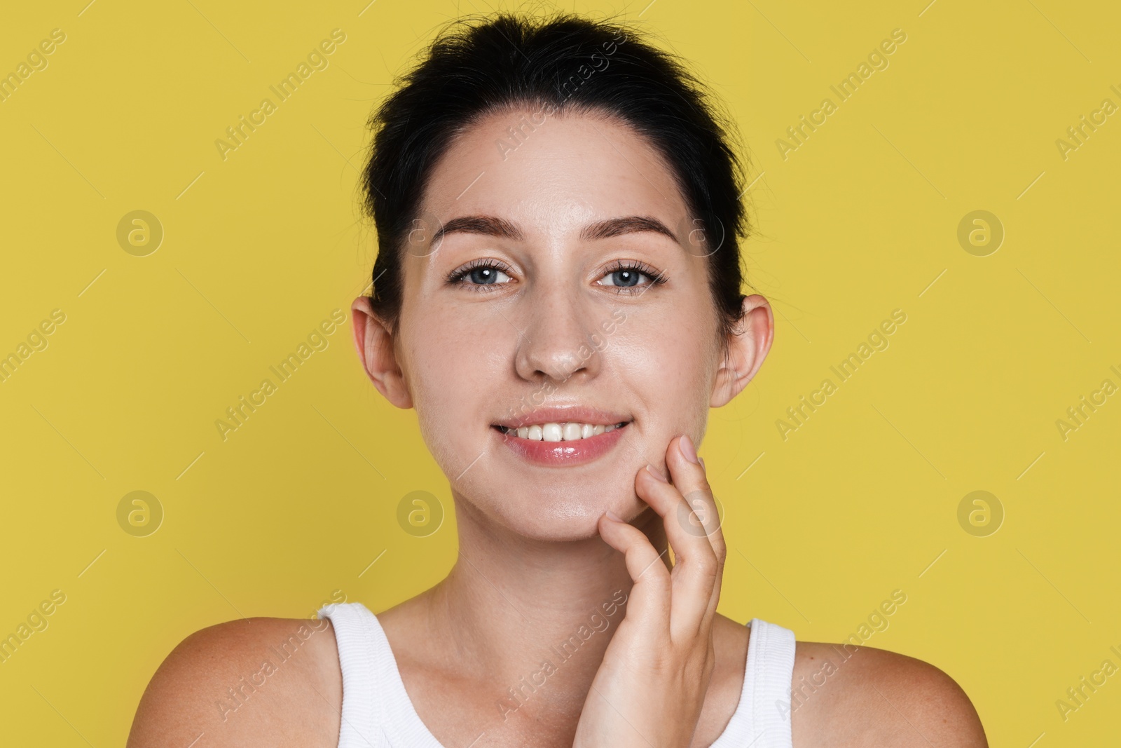 Portrait of smiling woman after dental aligners treatment on yellow background Photo of Portrait of smiling woman after dental aligners treatment on yellow background