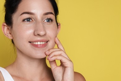 Photo of Smiling woman after dental aligners treatment on yellow background, closeup. Space for text