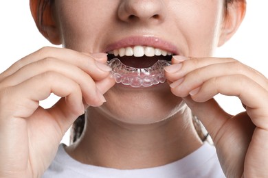 Photo of Woman wearing dental aligner on white background, closeup
