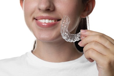 Photo of Smiling woman with dental aligner on white background, closeup
