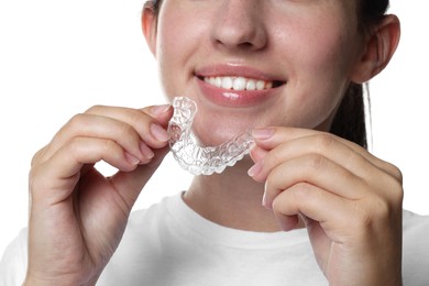 Photo of Smiling woman with dental aligner on white background, closeup
