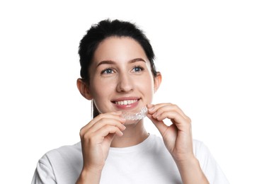 Photo of Smiling woman wearing dental aligner on white background
