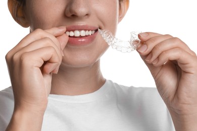 Photo of Smiling woman with dental aligner on white background, closeup