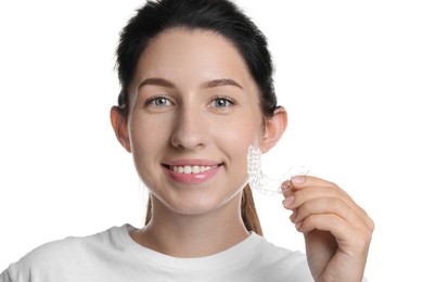 Photo of Portrait of smiling woman with dental aligner on white background, closeup