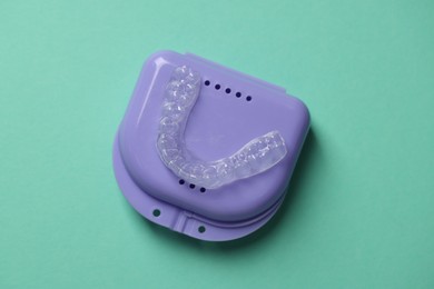 Photo of Clear aligner and retainer case on turquoise background, top view