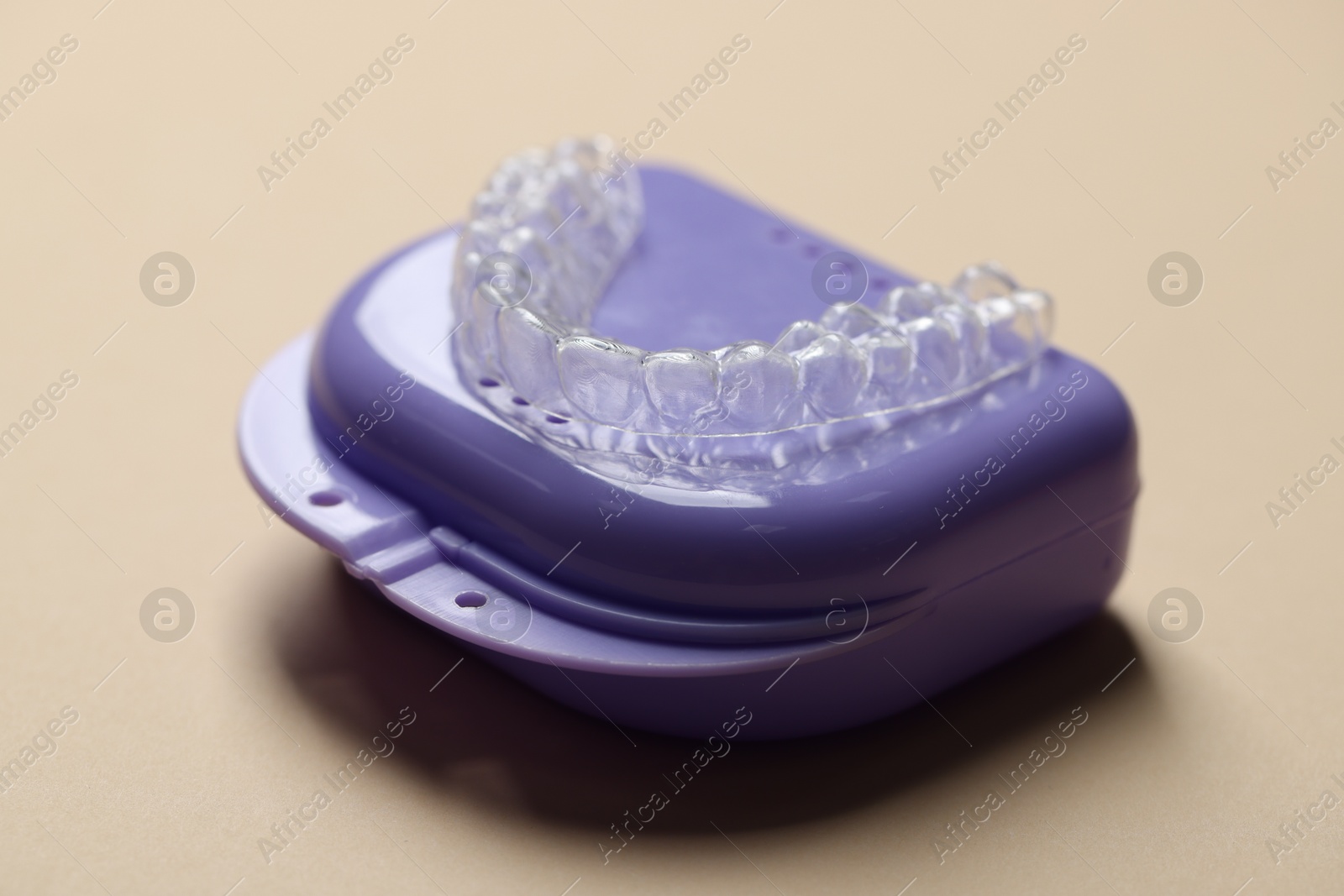 Clear aligner and retainer case on beige background, closeup Photo of Clear aligner and retainer case on beige background, closeup