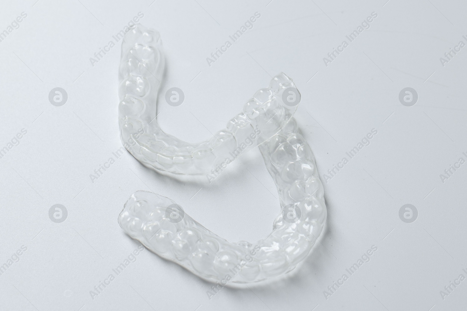 Clear aligners on light grey background, closeup Photo of Clear aligners on light grey background, closeup