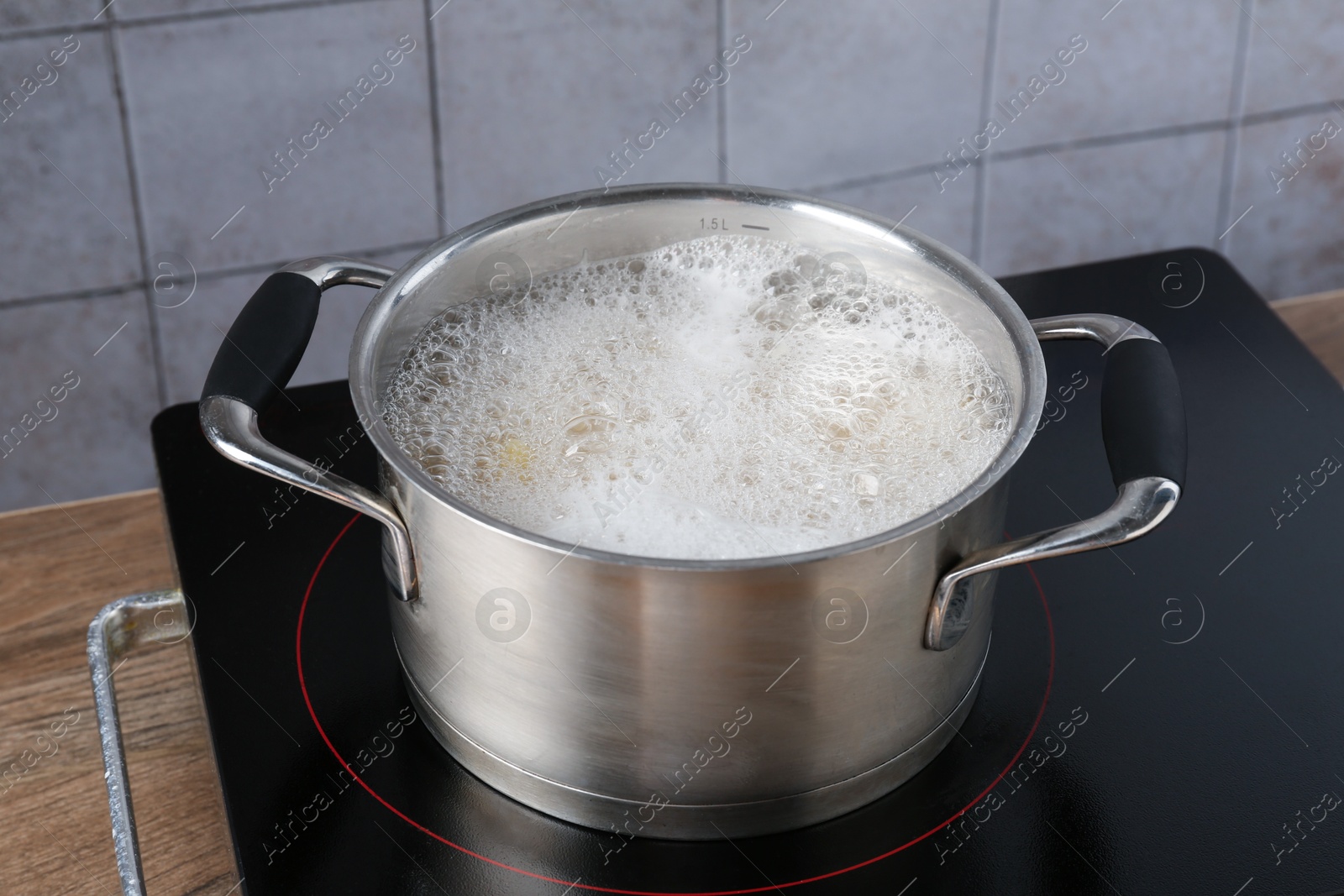 Fresh pasta boiling in pot with water on electric stove, closeup Photo of Fresh pasta boiling in pot with water on electric stove, closeup