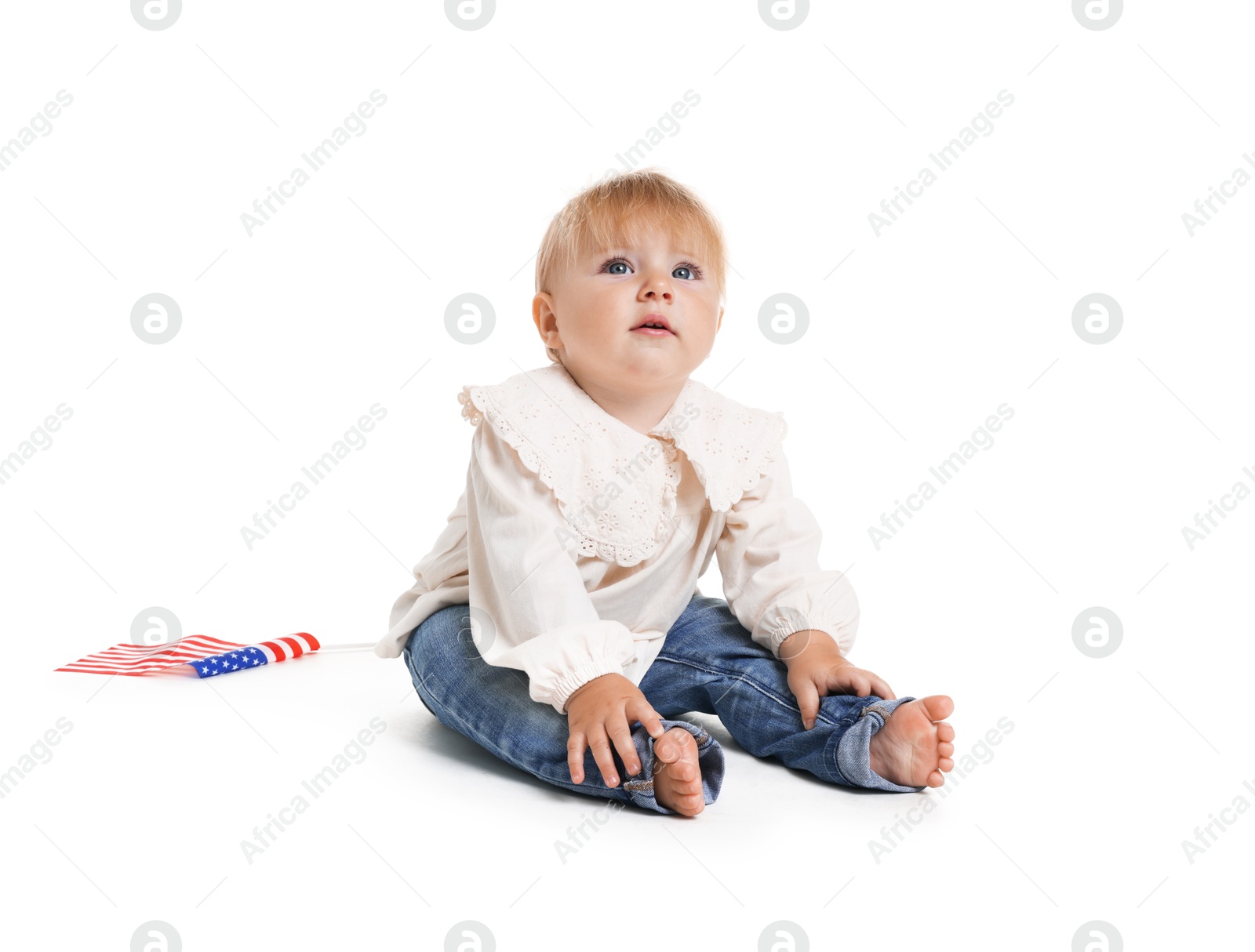 Photo of Cute little child with flag of USA on white background