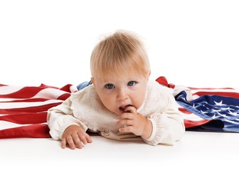 Photo of Cute little child with flag of USA on white background