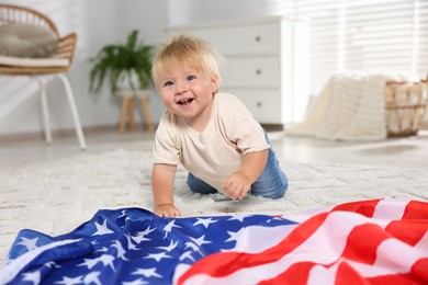 Photo of Cute little child with flag of USA on floor at home