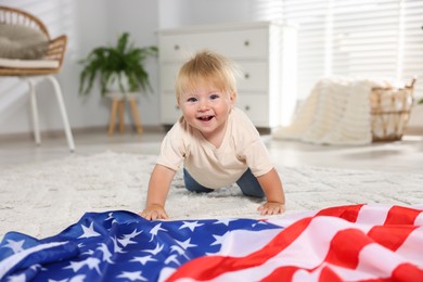 Photo of Cute little child with flag of USA on floor at home