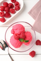 Photo of Delicious raspberry sorbet with mint in bowl, spoon and fresh berries on white wooden table, flat lay