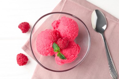Photo of Delicious raspberry sorbet with mint in bowl, spoon and fresh berries on white wooden table, flat lay