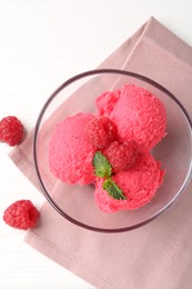Photo of Delicious raspberry sorbet with mint in bowl, napkin and fresh berries on white wooden table, flat lay
