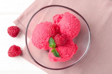 Photo of Delicious raspberry sorbet with mint in bowl, napkin and fresh berries on white wooden table, flat lay