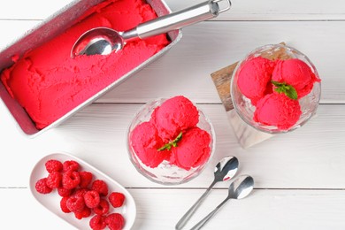 Photo of Delicious raspberry sorbet with mint and fresh berries served on white wooden table, flat lay