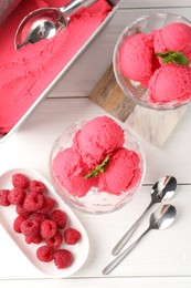 Photo of Delicious raspberry sorbet with mint and fresh berries served on white wooden table, flat lay