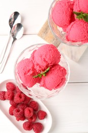 Photo of Delicious raspberry sorbet with mint in dessert bowls, spoons and fresh berries on white wooden table, flat lay