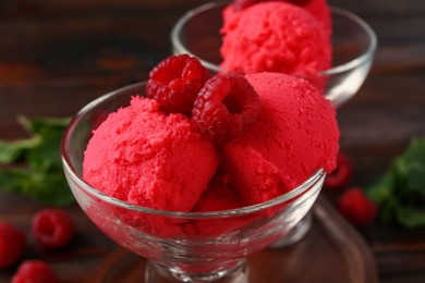 Photo of Delicious raspberry sorbet and fresh berries in dessert bowl on table, closeup
