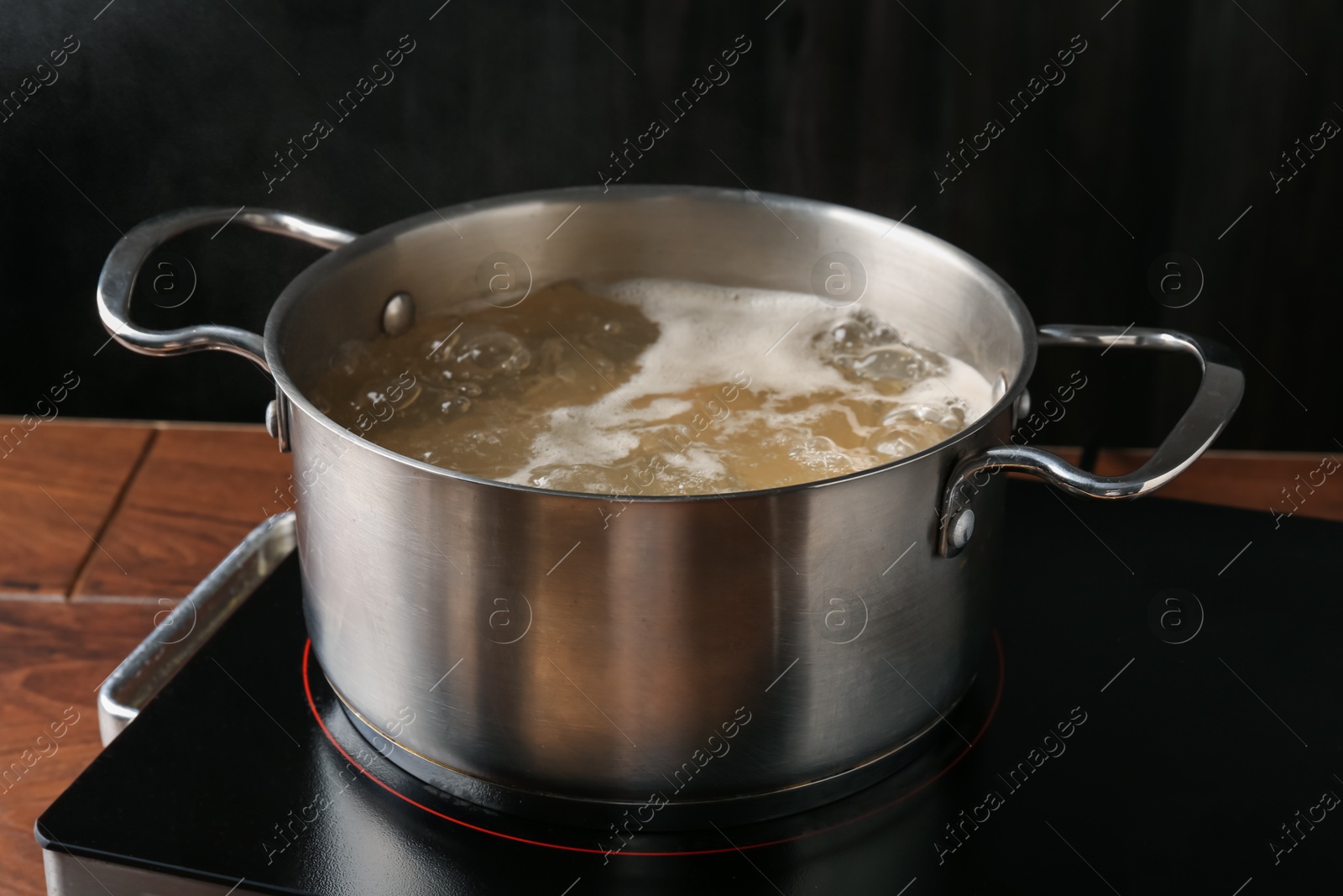 Fresh tagliatelle pasta boiling in pot with water on electric stove, closeup Photo of Fresh tagliatelle pasta boiling in pot with water on electric stove, closeup