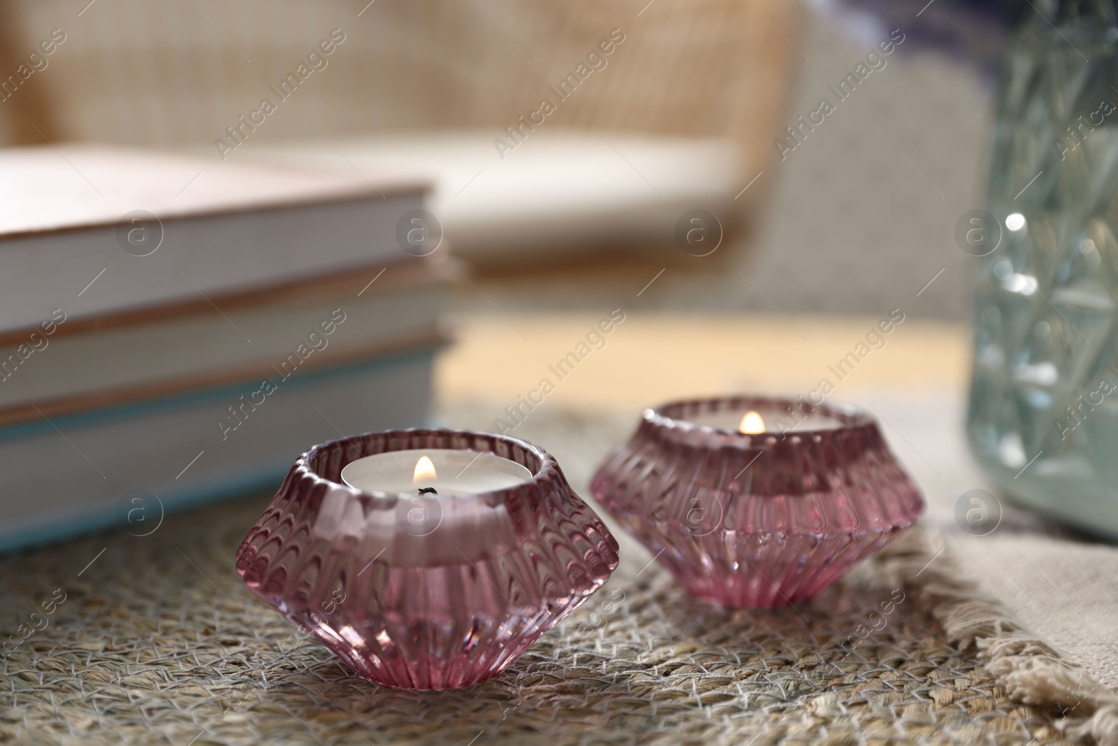 Spa composition with burning candles and books on table, closeup Photo of Spa composition with burning candles and books on table, closeup