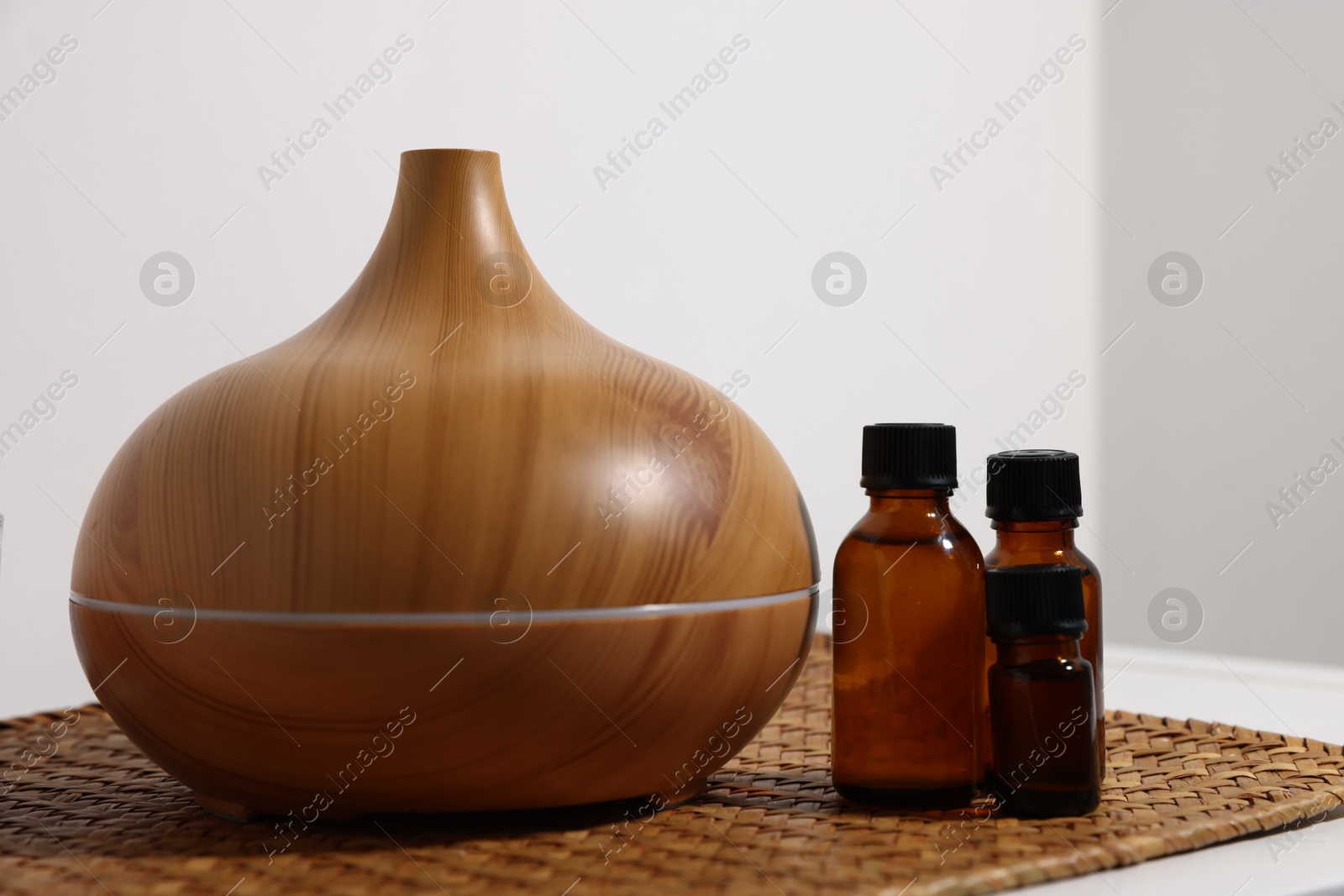 Spa composition with aroma oil diffuser and cosmetic products on table indoors, closeup Photo of Spa composition with aroma oil diffuser and cosmetic products on table indoors, closeup