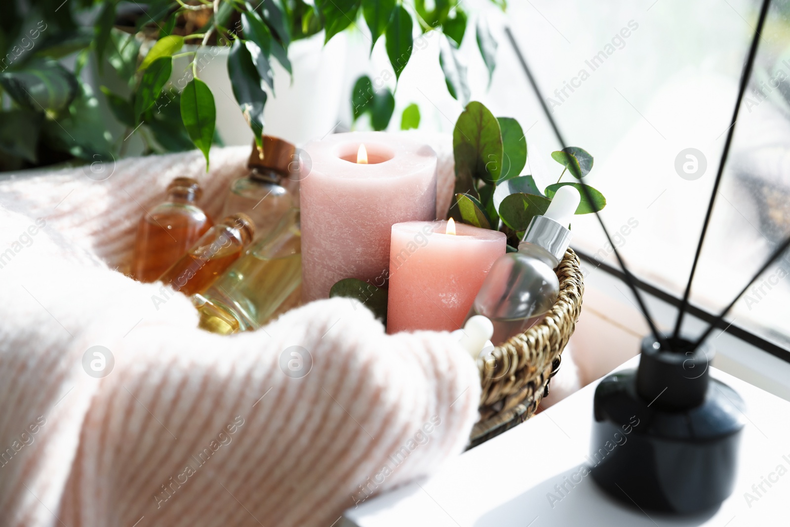 Spa composition. Burning candles, cosmetic products and reed air freshener on table indoors, closeup Photo of Spa composition. Burning candles, cosmetic products and reed air freshener on table indoors, closeup