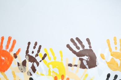 Photo of Tolerance concept. Colorful handprints on white background, flat lay. Space for text