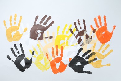Photo of Tolerance concept. Colorful handprints on white background, flat lay