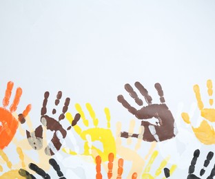 Photo of Tolerance concept. Colorful handprints on white background, flat lay. Space for text