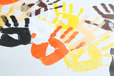 Photo of Tolerance concept. Colorful handprints on white background, closeup