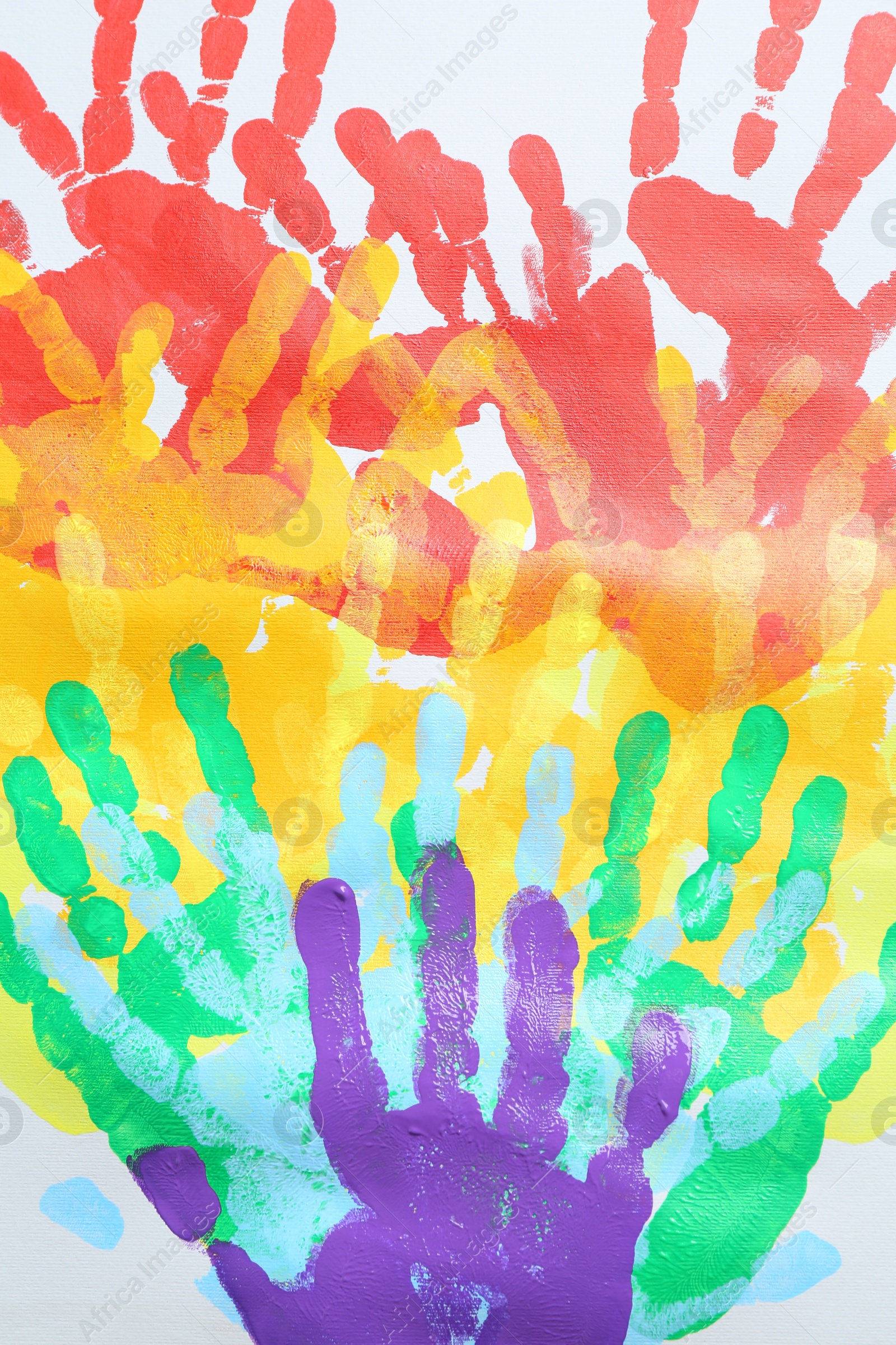 Tolerance concept. Heart of colorful handprints on white background, closeup Photo of Tolerance concept. Heart of colorful handprints on white background, closeup