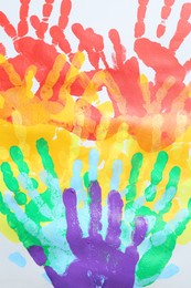 Photo of Tolerance concept. Heart of colorful handprints on white background, closeup