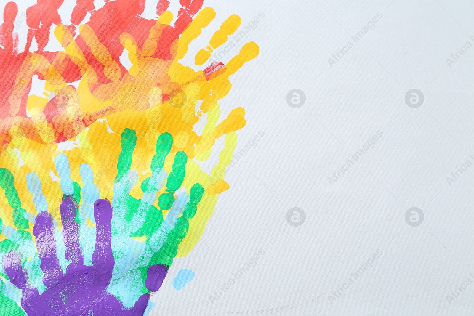 Tolerance concept. Heart of colorful handprints on white background, closeup. Space for text Photo of Tolerance concept. Heart of colorful handprints on white background, closeup. Space for text