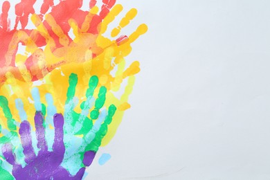 Photo of Tolerance concept. Heart of colorful handprints on white background, closeup. Space for text