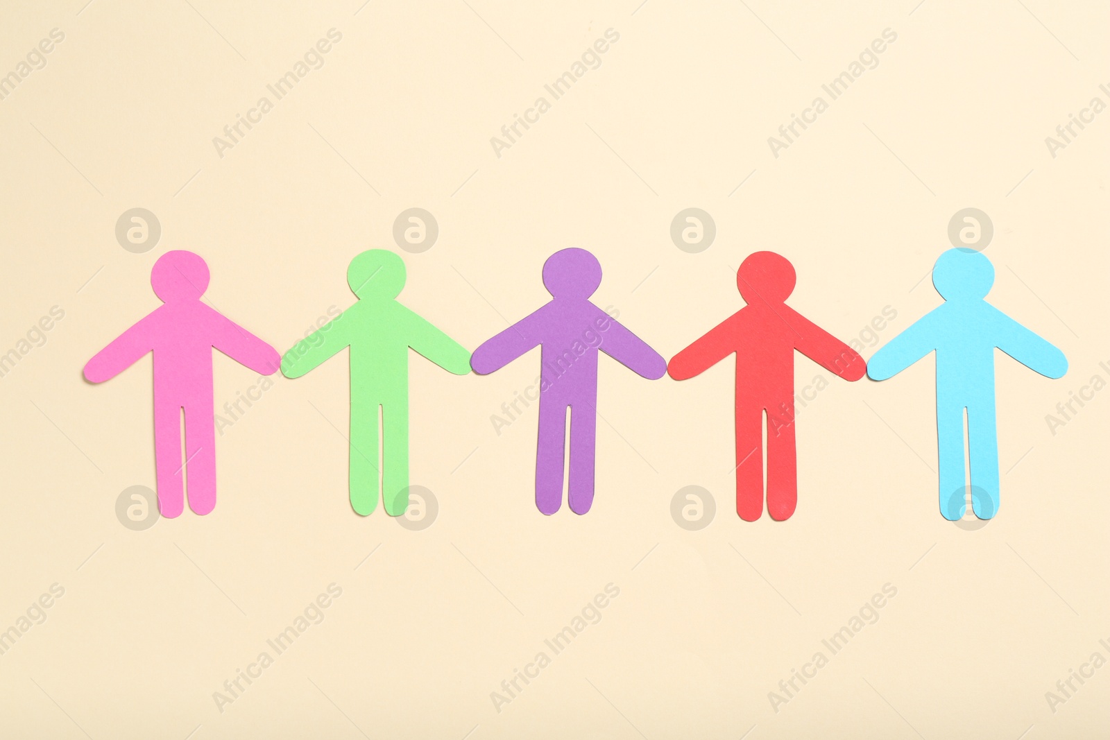 Tolerance concept. Colorful human figures on beige background, flat lay Photo of Tolerance concept. Colorful human figures on beige background, flat lay