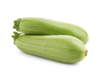 Photo of Two fresh ripe zucchinis isolated on white