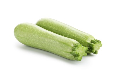 Photo of Two fresh ripe zucchinis isolated on white