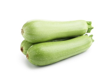 Photo of Three fresh ripe zucchinis isolated on white
