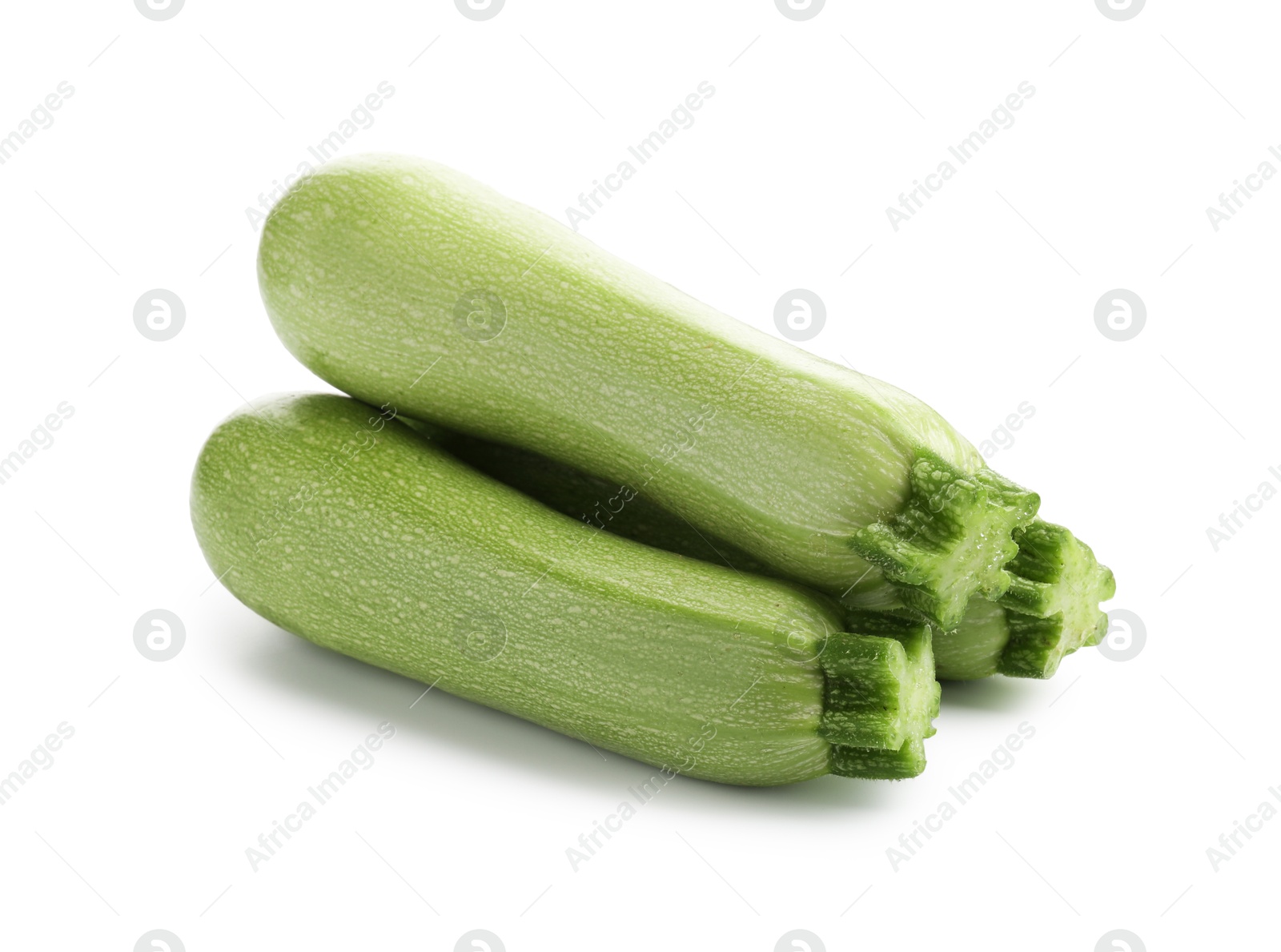 Three fresh ripe zucchinis isolated on white Photo of Three fresh ripe zucchinis isolated on white