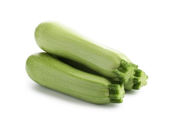 Photo of Three fresh ripe zucchinis isolated on white