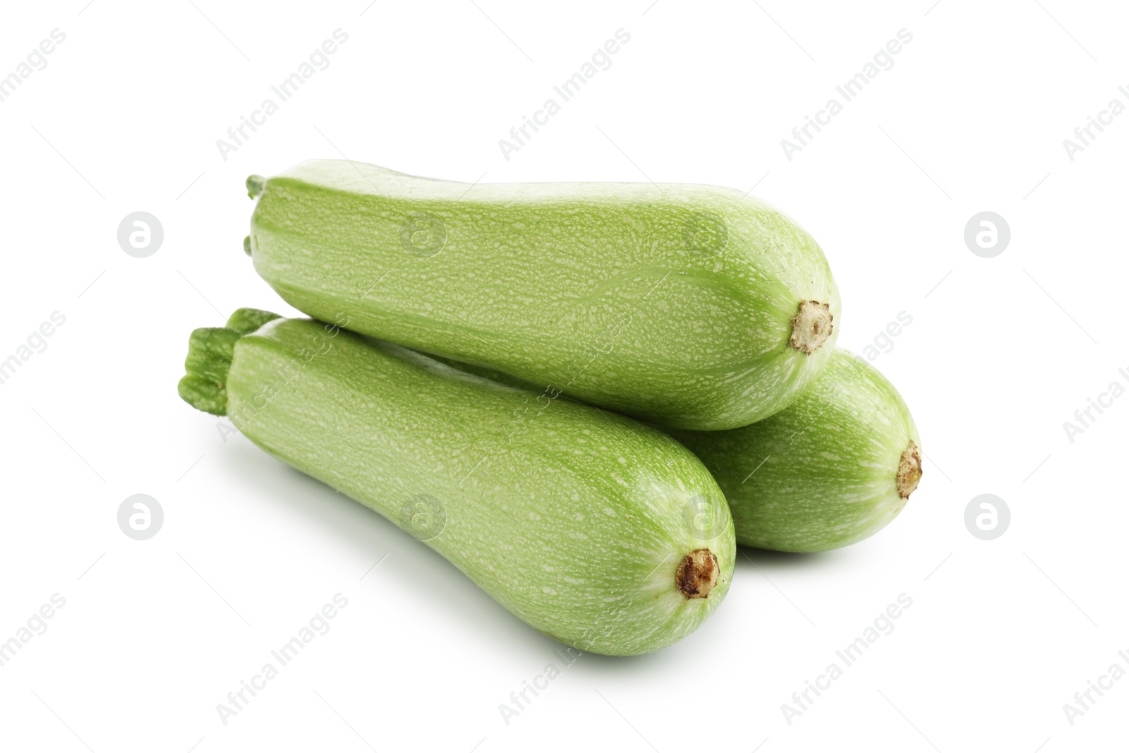Photo of Three fresh ripe zucchinis isolated on white