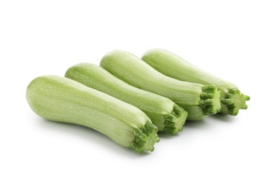 Photo of Many fresh ripe zucchinis isolated on white