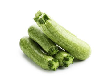 Photo of Many fresh ripe zucchinis isolated on white