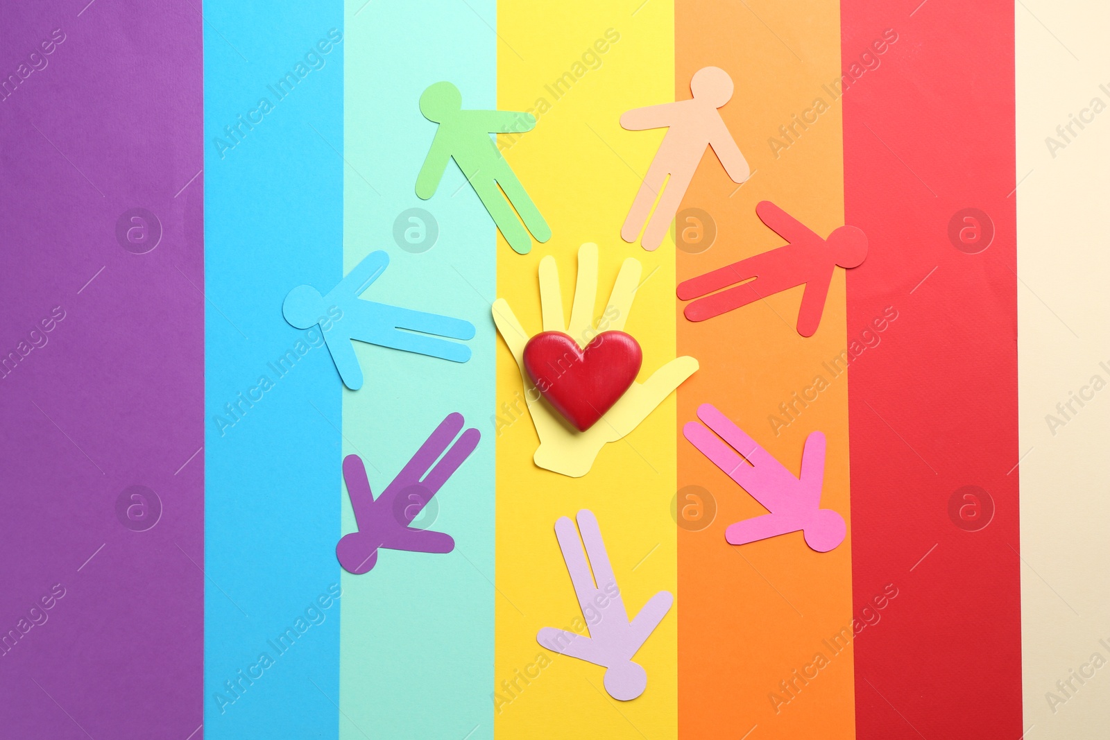 Tolerance concept. Paper human figures and heart on colorful background, flat lay Photo of Tolerance concept. Paper human figures and heart on colorful background, flat lay
